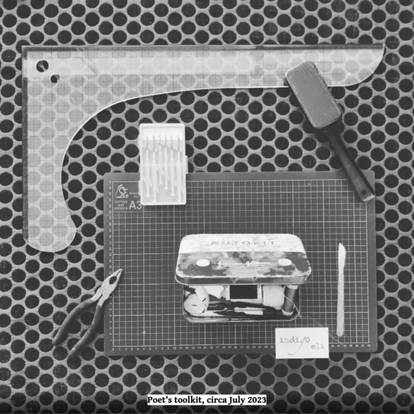 a square black and white photo of indigo’s poetic tools … an assortment of objects are laid out on a dark polka dot fabric, in a deliberate design, all connected by touch ... flowing from the top left a plastic right angle french curve ruler, a fabric lint brush, a gridded A3 cutting board, a boxed set of small screwdrivers, a pair of pliers, a vintage auto toolkit tin filled with threads and snips and vintage velvet metal pin cushion and other assorted bits and bobs, a silver scalpel ... and at the bottom of the cutting mat, an indigo eli calling card. an artefact label added to the bottom of the image, black text on white reads: Poet's tool kit, circa July 2023.