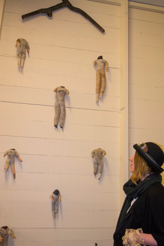 Child Protection. Act. .. the artist standing with her artwork .. a mirror image of the previous photo .. the artist stands in the bottom right corner of the image looking directly up